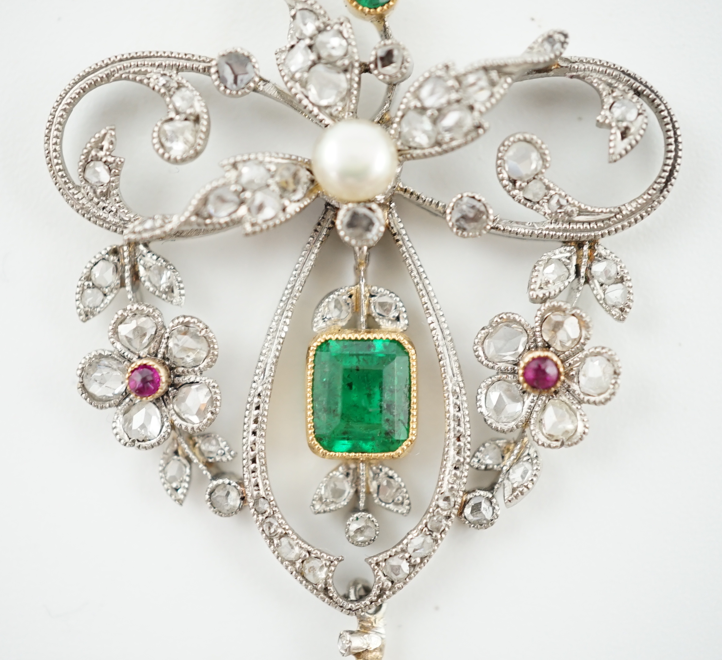 A Belle Epoque gold and platinum, emerald, pearl, ruby and diamond cluster set drop pendant brooch